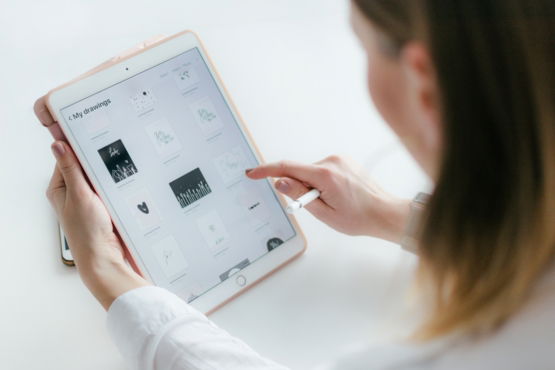woman using gold iPad